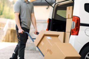 Courier Service A medical supplies courier using a hand truck to deliver several large medical supply packages